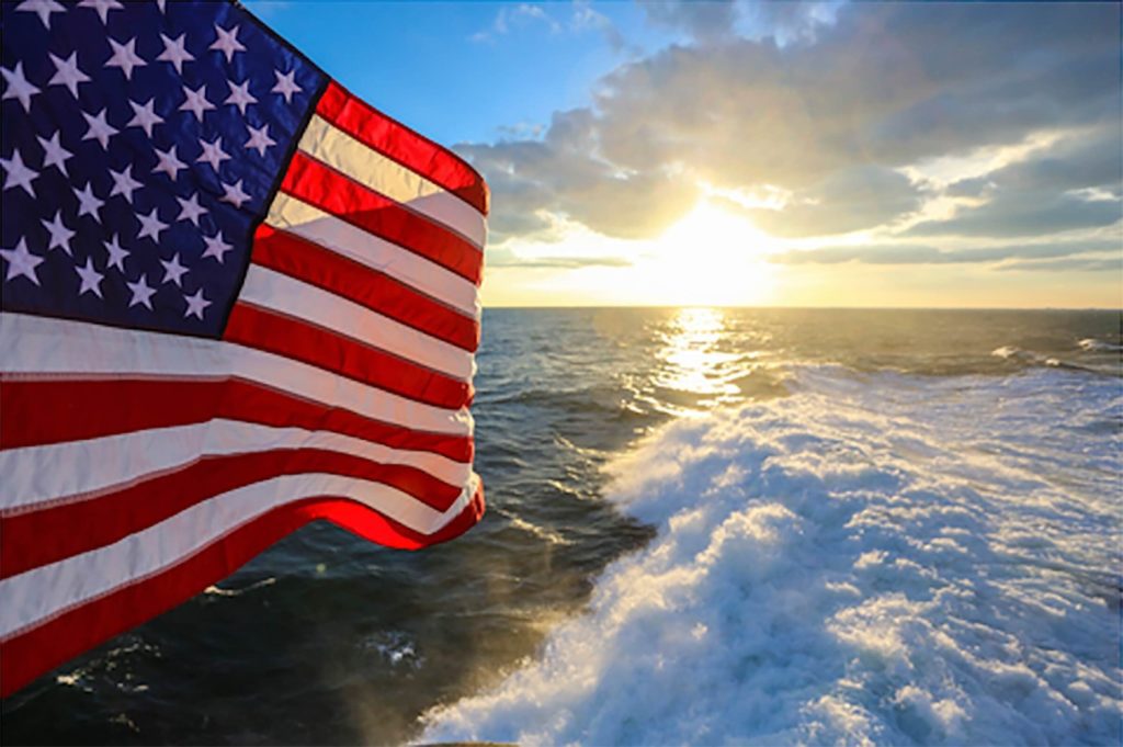 american flag with sunset