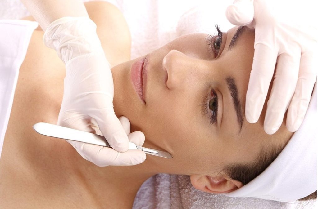 dermaplaning facial on woman at spa